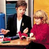 University Hospital PT, Lynne Logan with young patient.