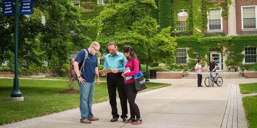 Wilkens with students in front of Wsk Hall